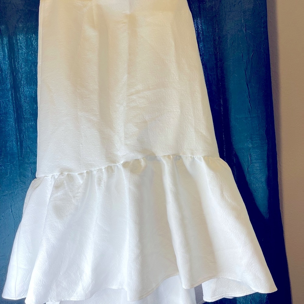 All white pencil skirt with ruffle bottom